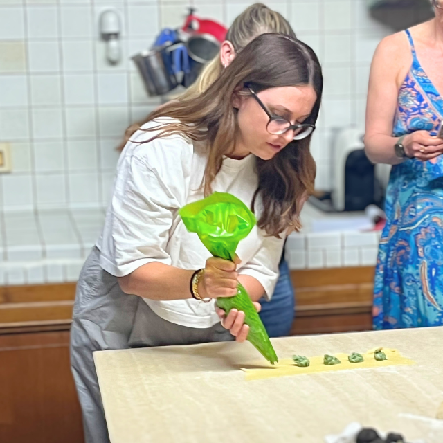 student making pasta in Italy with a piping bag