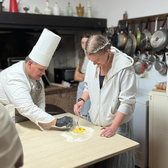 student making pasta in Italy with an Italian chef