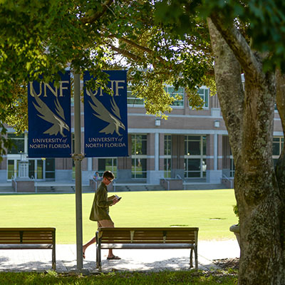 student walking across campus