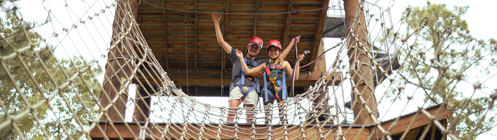 two students standing at the top of the ropes