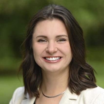 A picture of a woman smiling for a photograph.