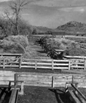 Picturesque Bridge over irrigation cannal going to a hay field. Mountain in background