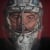 Seattle Kraken Goalie, Philipp Grubauer in his full face mask against a red background