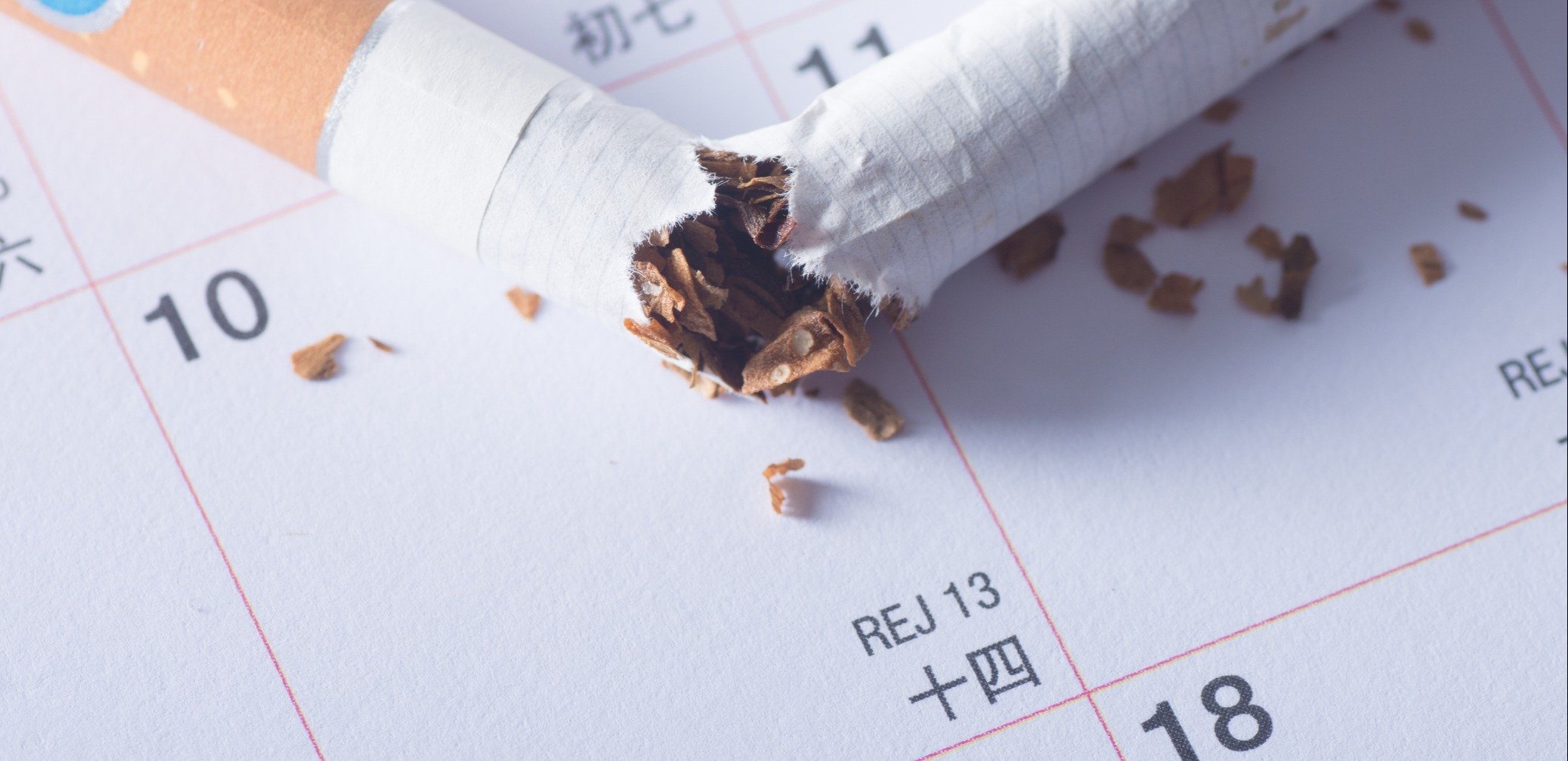 Close-Up Of Cigarette On Calendar