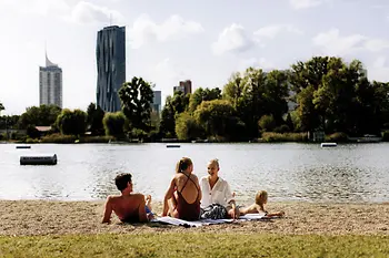 Gänsehäufel lido on the Old Danube: a man, two women, and a child on the beach