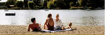 Gänsehäufel lido on the Old Danube: a man, two women, and a child on the beach