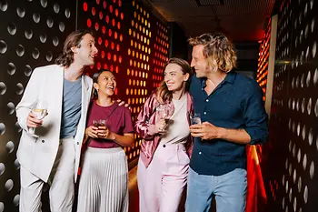 People in a disco with glasses in their hands