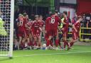 Swindon players celebrate the winner against Colchester