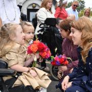 Princesses Beatrice and Eugenie were presented with flowers from Annabelle and Eva during a garden party at Haven House Children’s Hospice, Woodford Green (Theo Wood/PA)