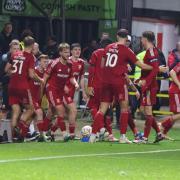 Swindon players celebrate the winner against Colchester