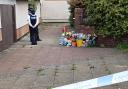 Flowers and a police cordon at Keele Close in Beechwood