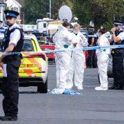 Police scenes-of-crime officers (SOCOs) at the scene in Southport