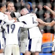 Harry Kane, second left, celebrates his second goal against Finland with team-mates (Nick Potts/PA)