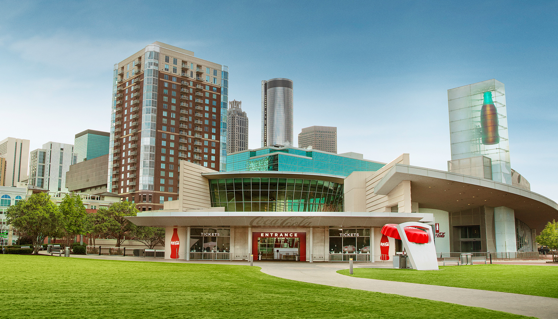 a view of the green lawn in front of the world of coke