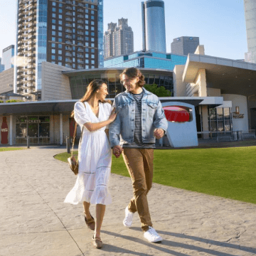 two people walking in a courtyard at world of coca-cola