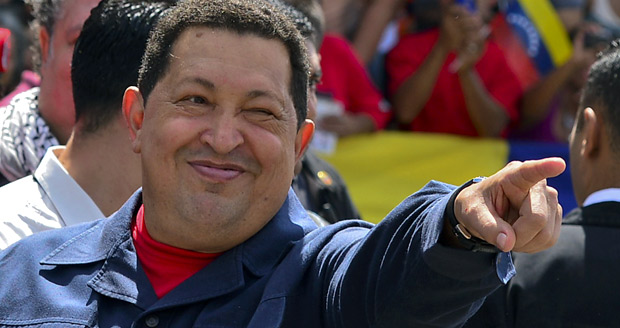 ORG XMIT: LAC078 -- AFP PICTURES OF THE YEAR 2012 -- Venezuelan President Hugo Chavez gestures before voting in Caracas on October 07, 2012. Venezuelans voted Sunday with President Hugo Chavez's 14-year socialist revolution on the line as the leftist leader faced youthful rival Henrique Capriles in his toughest electoral challenge yet. AFP PHOTO/Luis Acosta