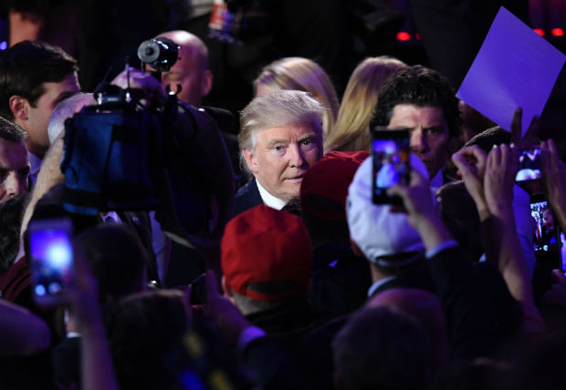 US President-elect Donald Trump greets supporters after speaking at the New York Hilton Midtown in New York on November 8, 2016. Trump stunned America and the world Wednesday, riding a wave of populist resentment to defeat Hillary Clinton in the race to become the 45th president of the United States. / AFP PHOTO / SAUL LOEB