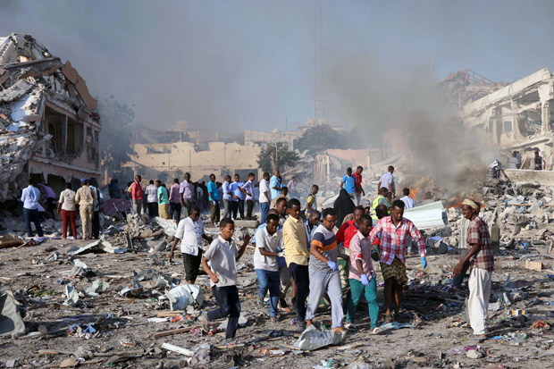 ATTENTION EDITORS - VISUAL COVERAGE OF SCENES OF DEATH Civilians carry the dead body of an unidentified man from the scene of an explosion in KM4 street in the Hodan district of Mogadishu, Somalia October 14, 2017. REUTERS/Feisal Omar ORG XMIT: GGGAFR120