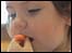 French child eating a carrot