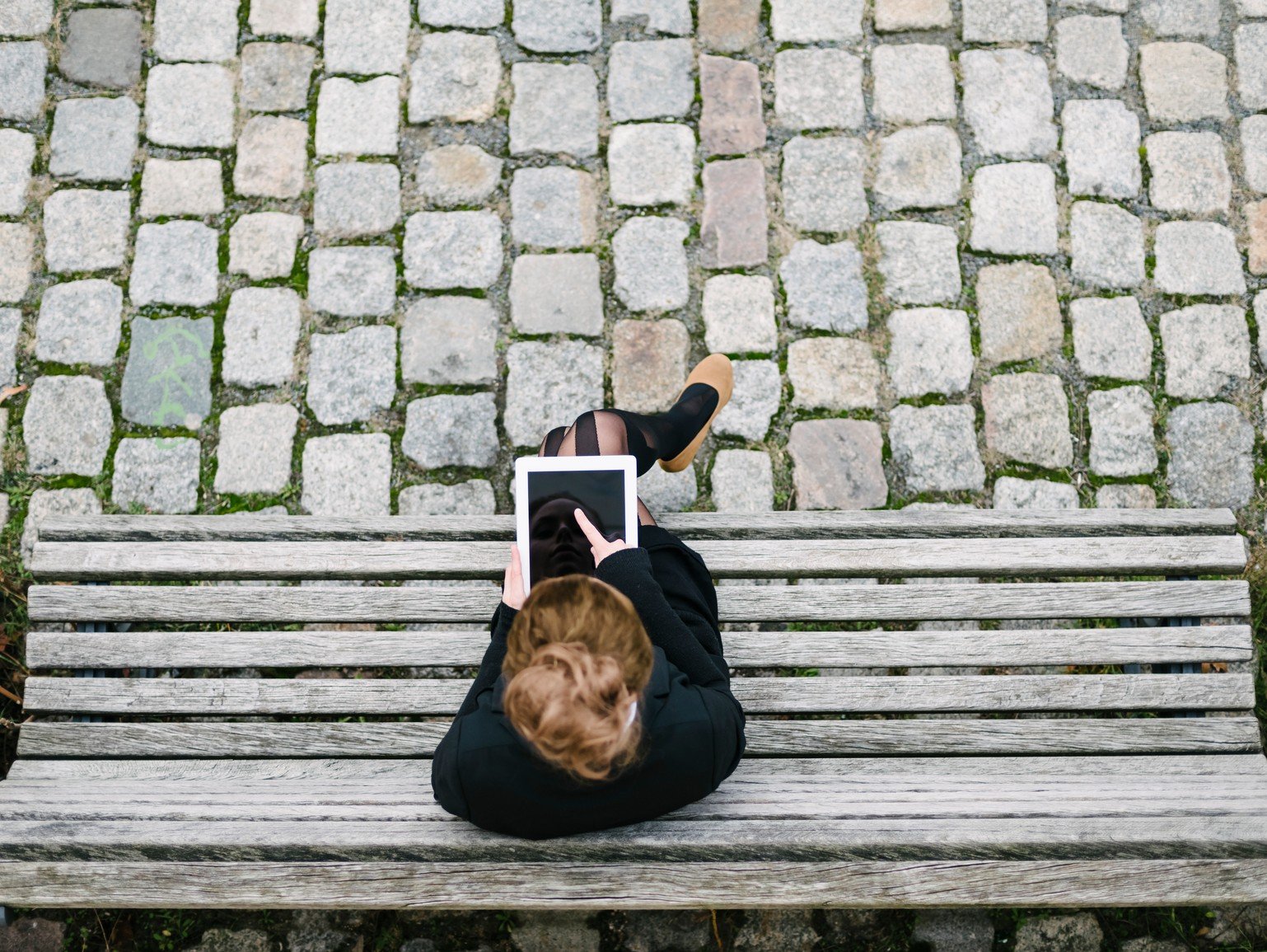 stock-generic-woman on bench with tablet