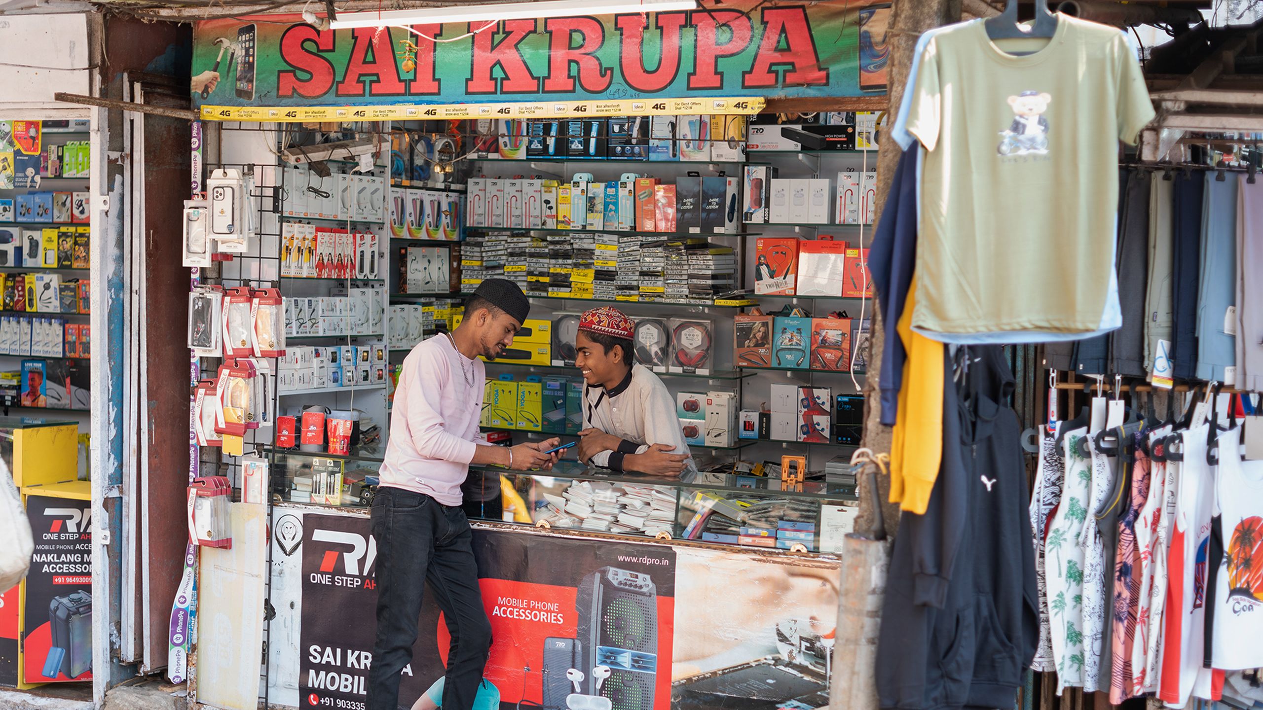 Two men talking in a kiosk in Mumbai