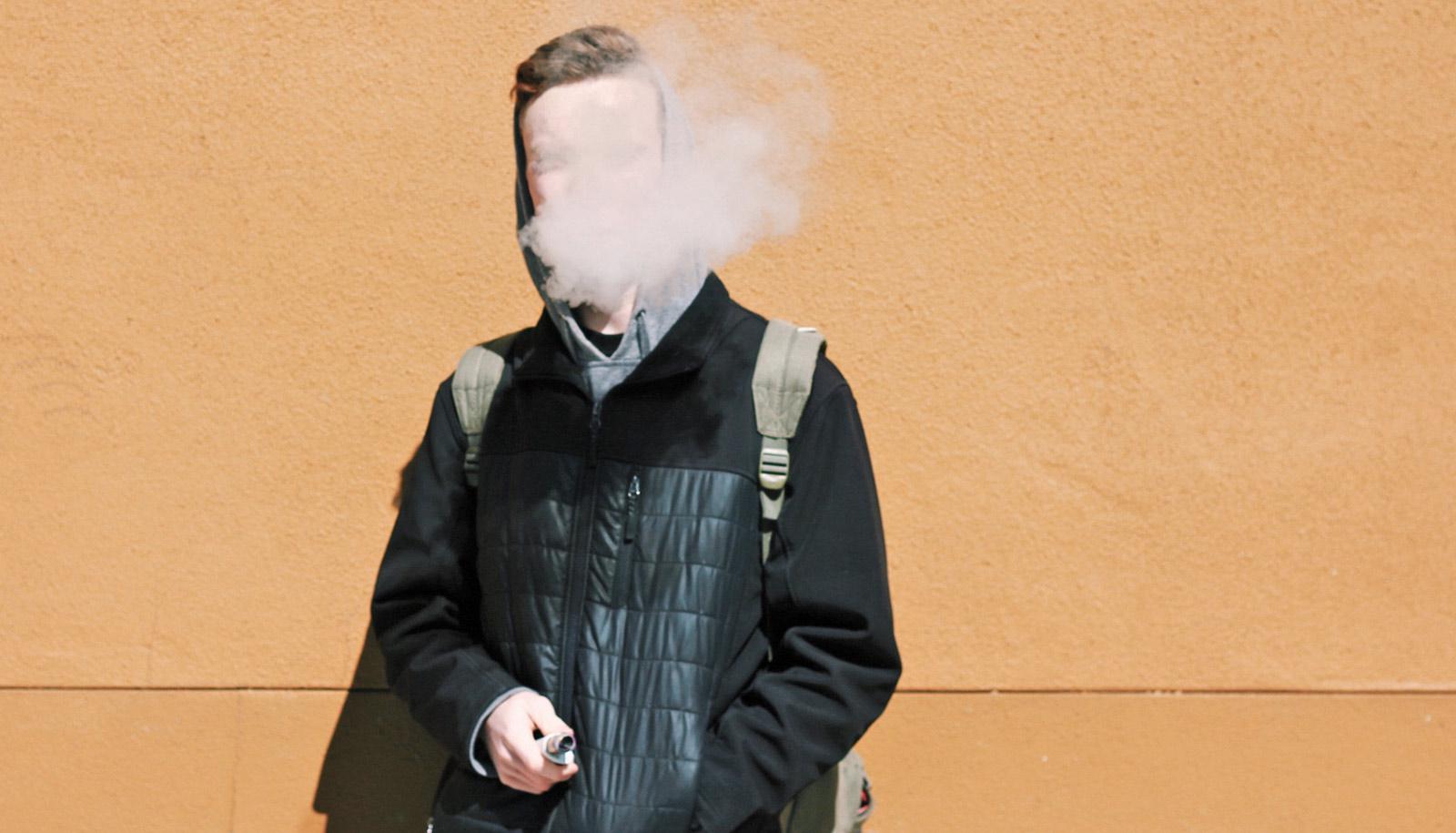 person in coat, backpack vapes