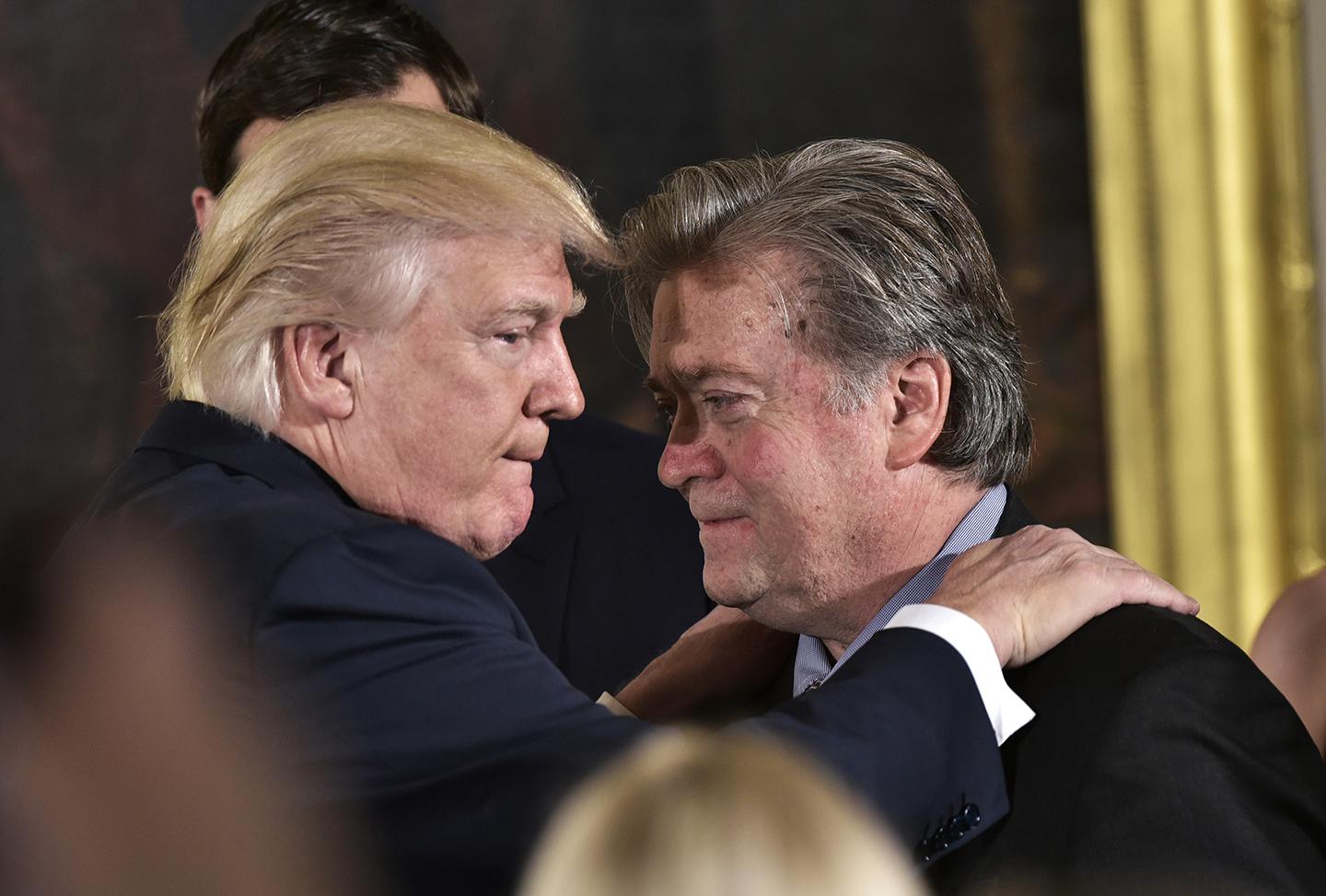 President Donald Trump congratulates Stephen Bannon during the swearing-in of senior staff in the East Room of the White House on January 22 in Washington, DC. He was out of the job by August.