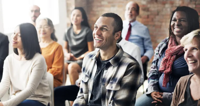 A group of employees enjoying an education session in an office training room.