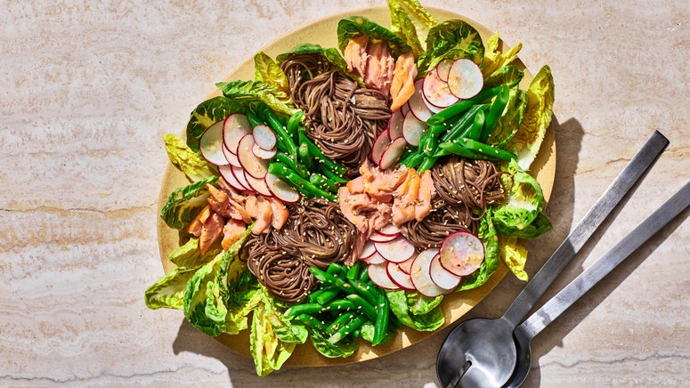 Salmon Noodle Salad on a stone background with utensils  to the side