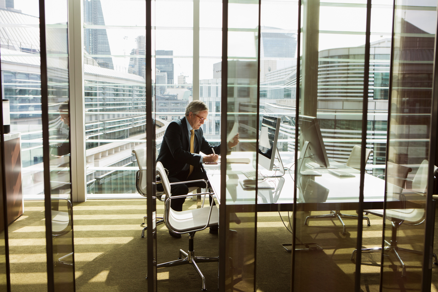 Businessman reading and analysing report, London, UK,