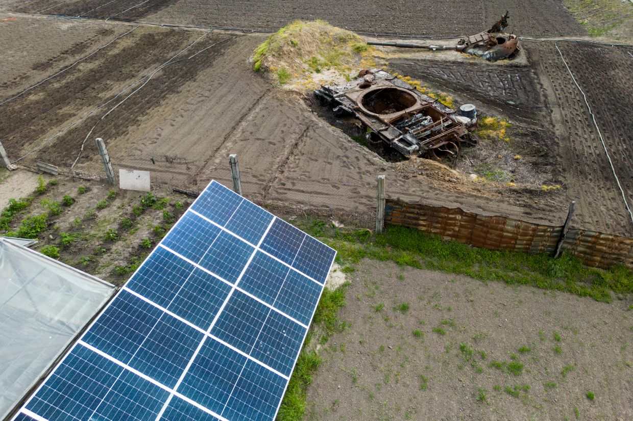 An aerial drone view shows a local resident's plants next to a destroyed Russian tank