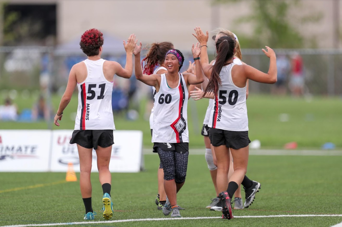 Students high-five each other on the field