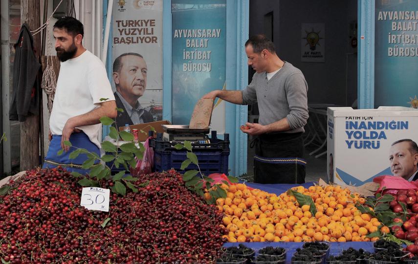 Vendors stand in their stall outside a local office of President Tayyip Erdogan's ruling AK Party, ahead of the May 28 runoff vote, at a fresh market in Istanbul, Turkey May 23, 2023.
