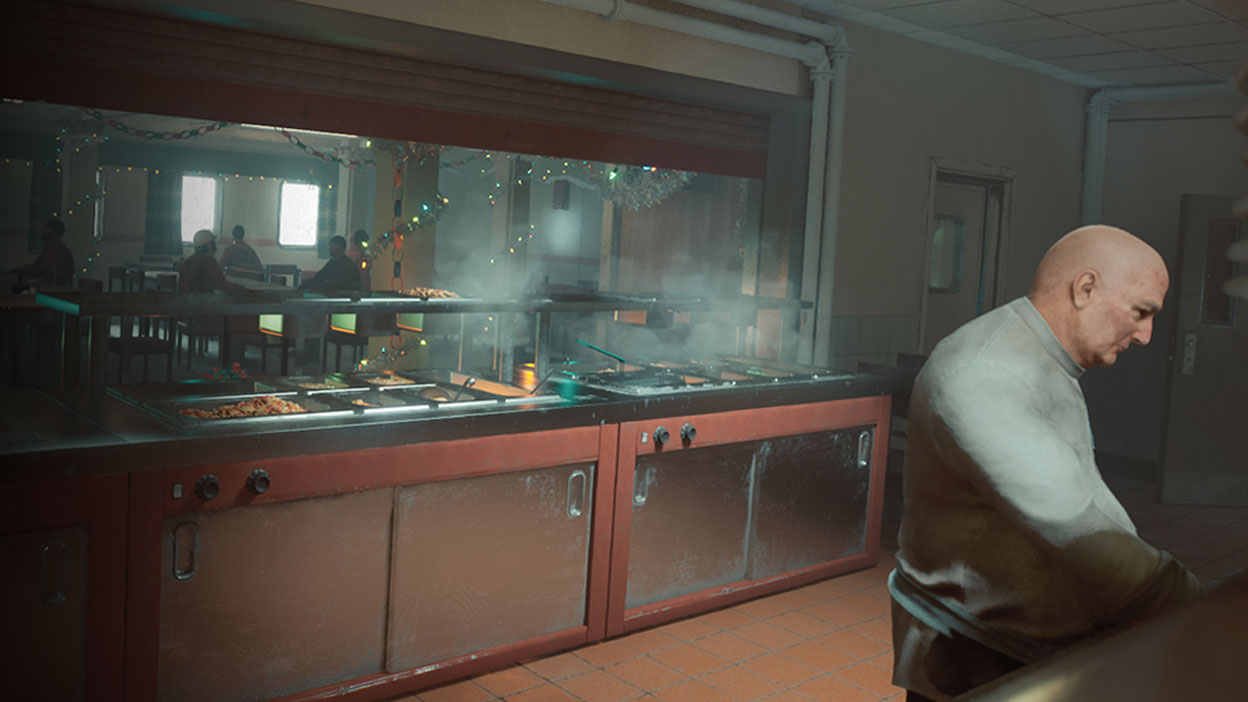 A man working in a cafeteria kitchen.