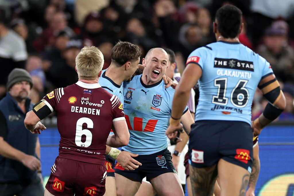 Dylan Edwards is hugged by NSW Blues teammates during State of Origin.