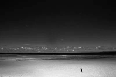 Lonely figure in shallow water