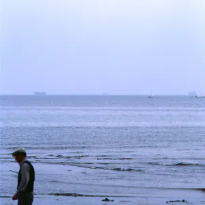 Old man walking beach