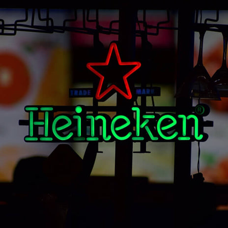 An LED neon sign of Heineken in green and the Heineken star in red