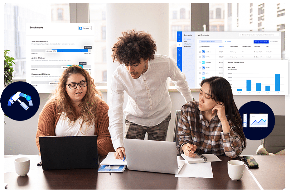 Three colleagues looking at computer monitors while discussing spend management