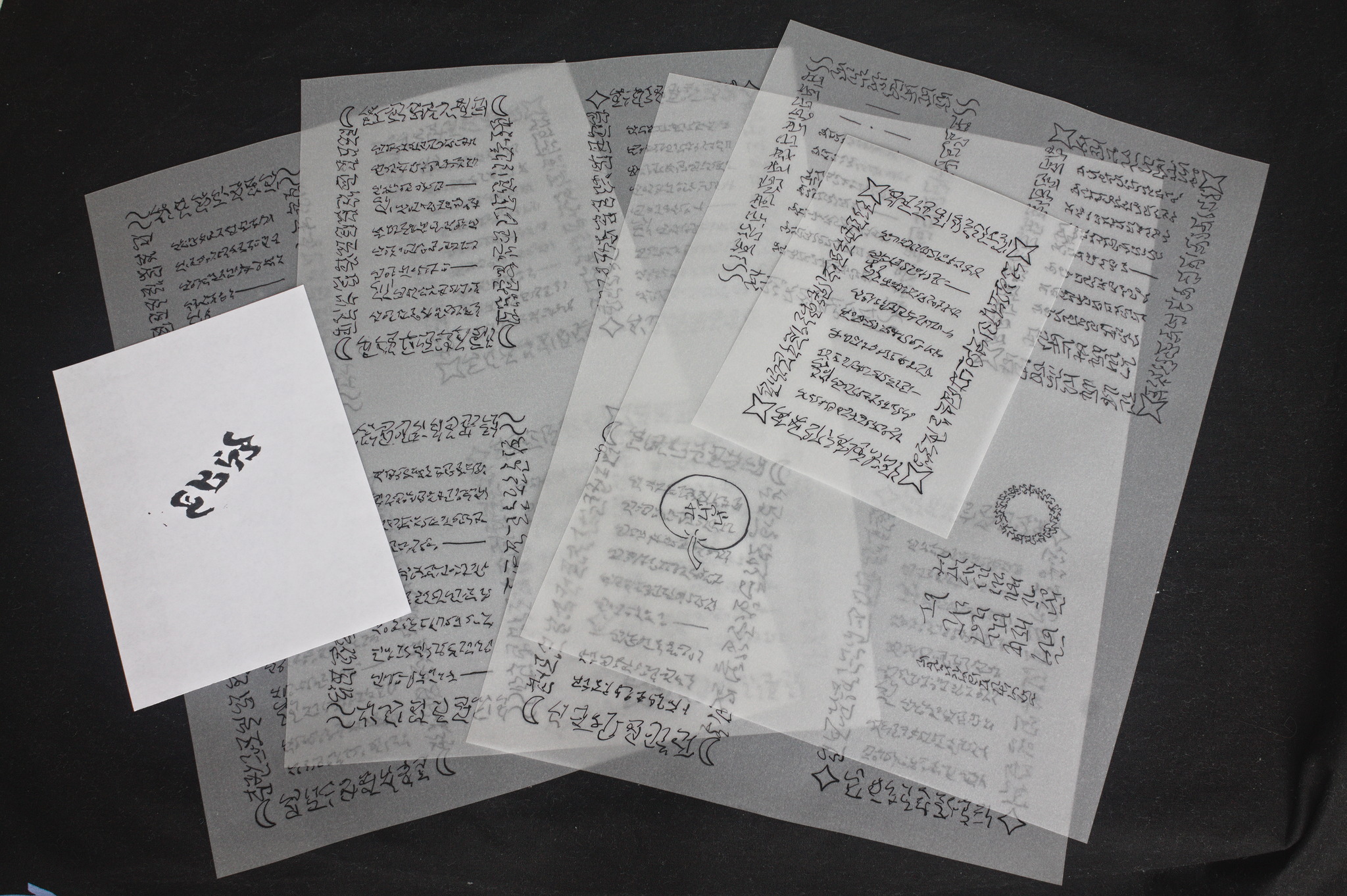 Multiple A4 sheet of tracing paper with fake text, plus an A6 sheet and a white A6 sheet with a stamp impression.