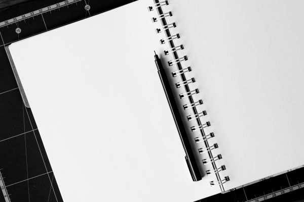 desk,notebook,table,black and white