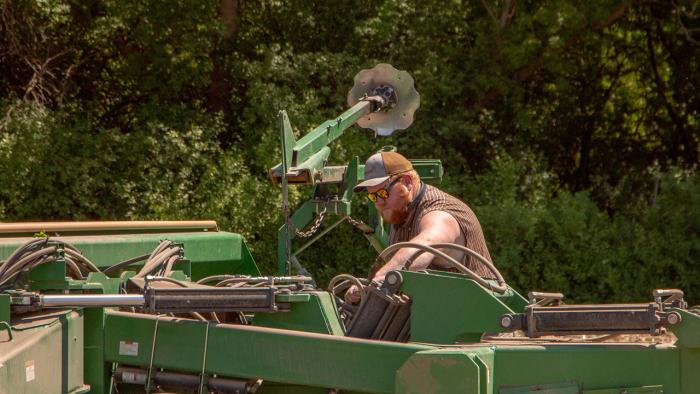 Farmer working on machinery.