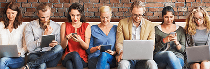 Multiple people seated on a bench reading a blog on various devices