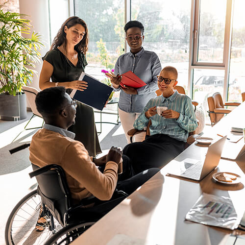 diverse team looks happy in conversation