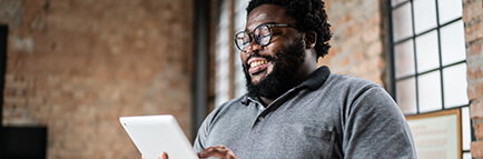 Man reading a newsletter on tablet