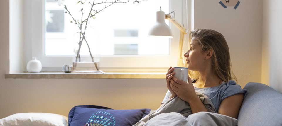 woman relaxing on couch with tea