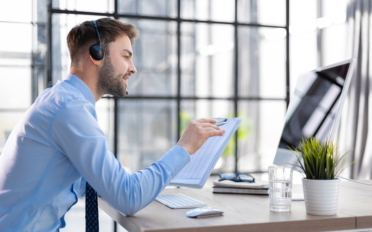 Man wearing headset working at a desk