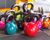 Colorful Kettlebells On Tiled Floor In Gym