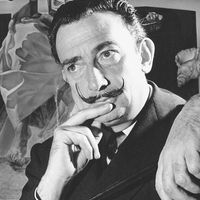 Portrait of Salvador Dali in front of painting "The Madonna of Port Lligat."