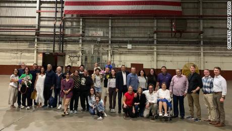 A group of seven Americans are pictured with their families and officials upon returning to the United States after being detained in Venezuela.